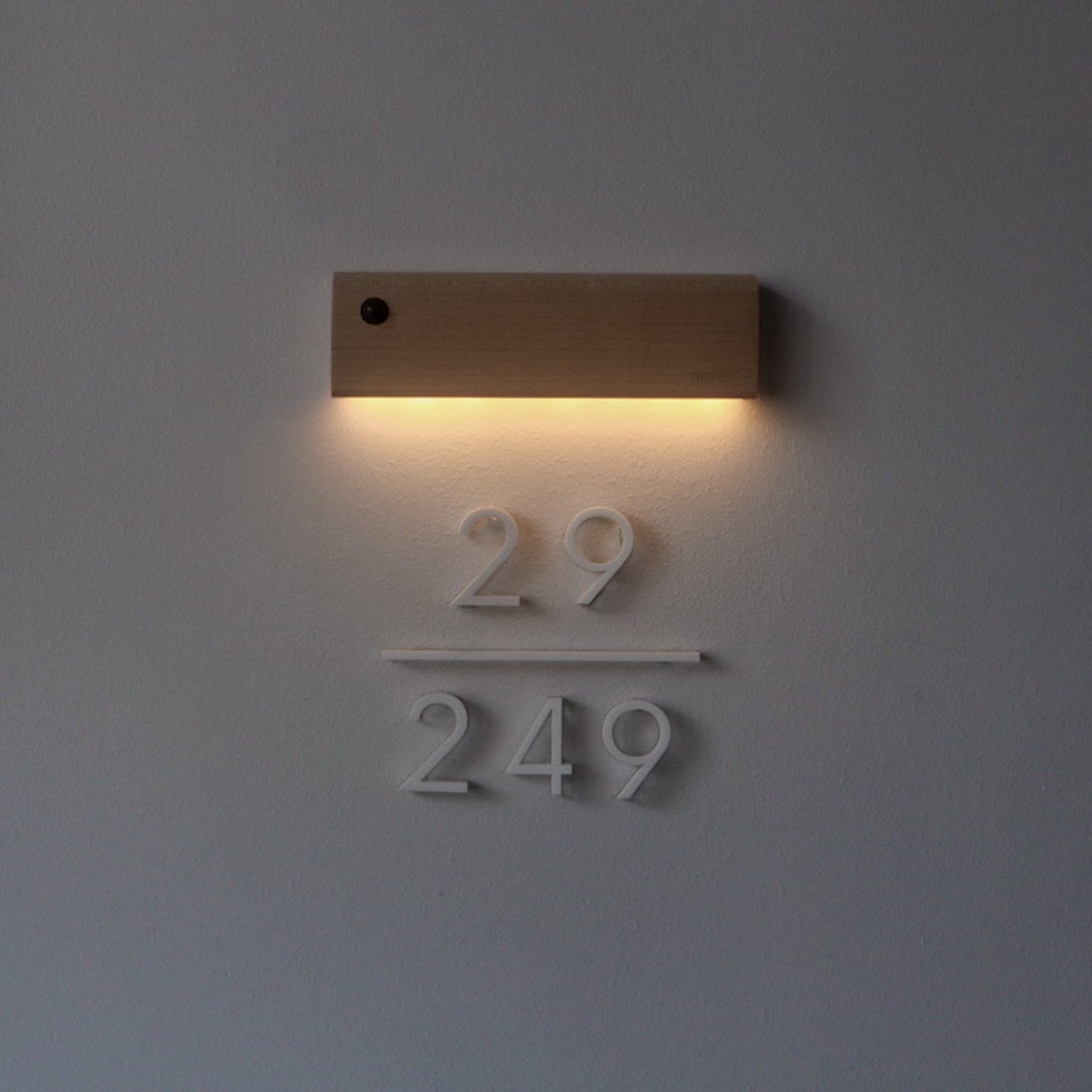 12cm Aria unit sign in matte white acrylic with "Our Silver Lining" light beam in light wood
