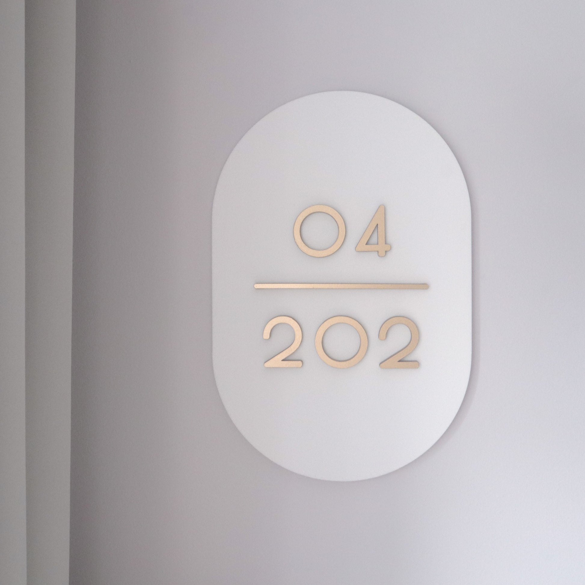 Customised Unit Number Sign in Singapore with matte white acrylic base and matte gold acrylic text